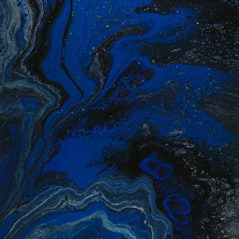 a close up of a blue and black liquid